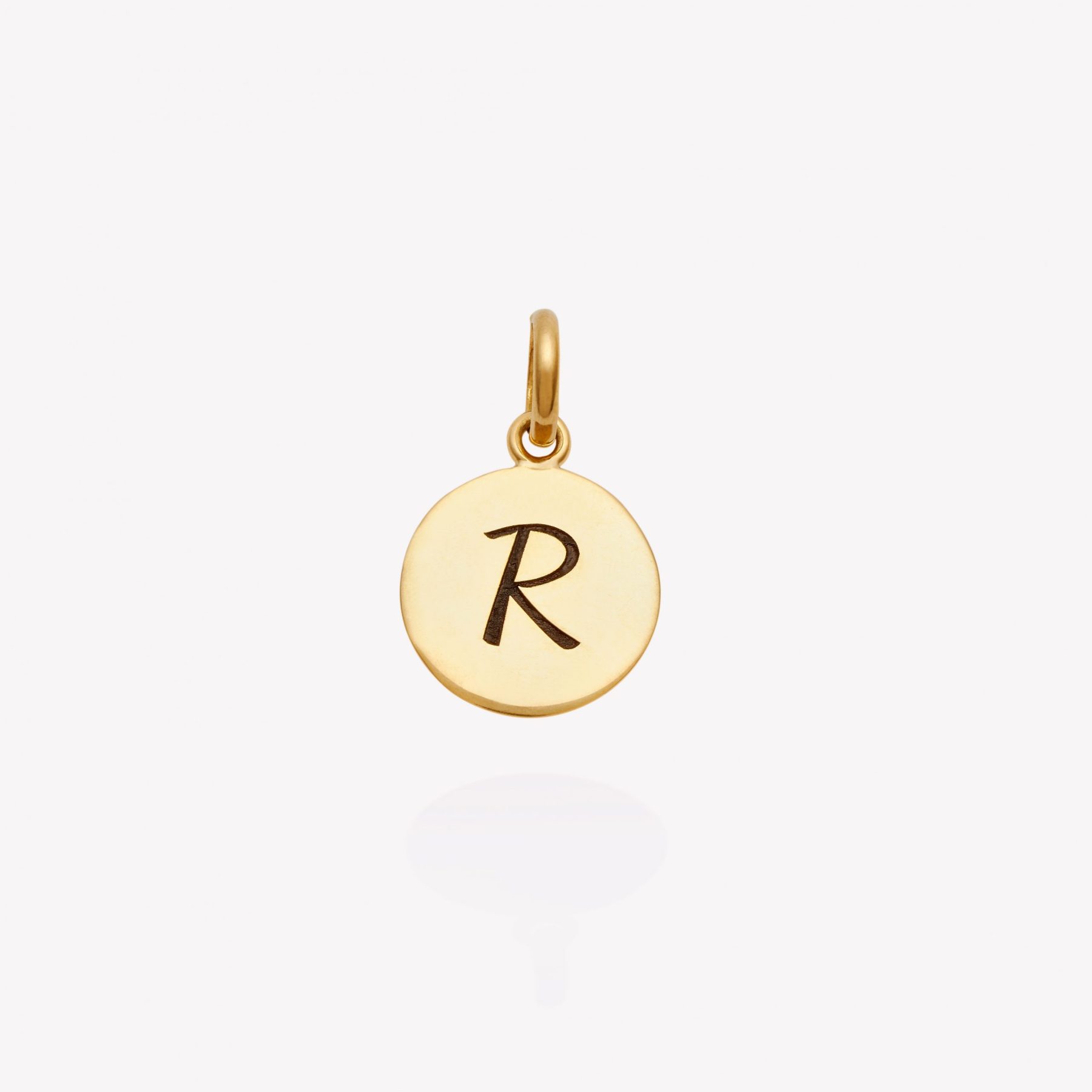 Placa oro 18 amarillo, redonda de 1.2 cm. inicial R.