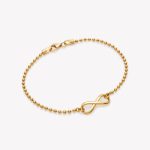 Pulsera bolitas con infinito en oro 18k. amarillo.