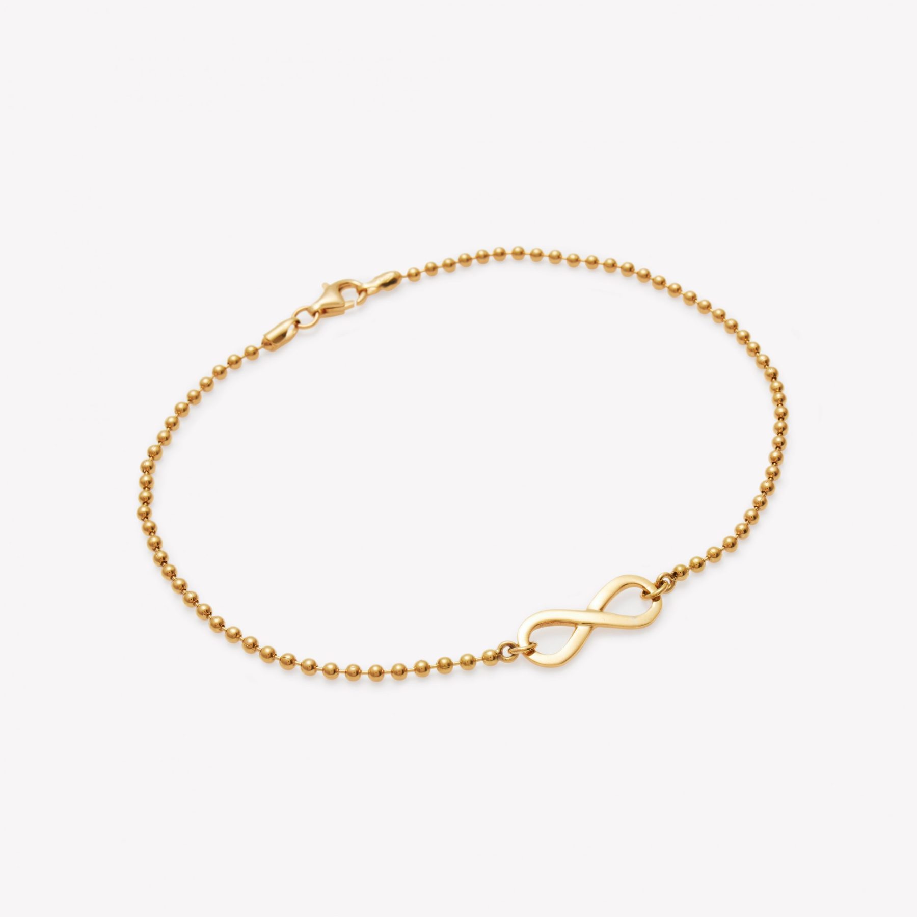 Tobillera en 18k. amarillo bolitas Infinito.